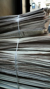 Stack of daily business newspapers.